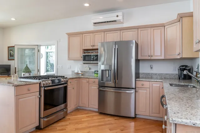 a kitchen with granite countertop stainless steel appliances and wooden cabinets