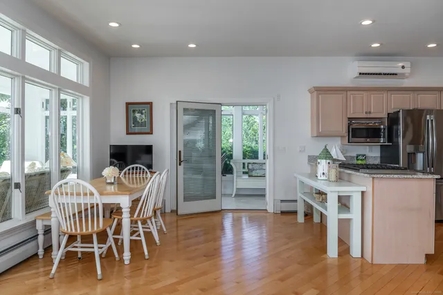 a view of a dining room with furniture and wooden floor