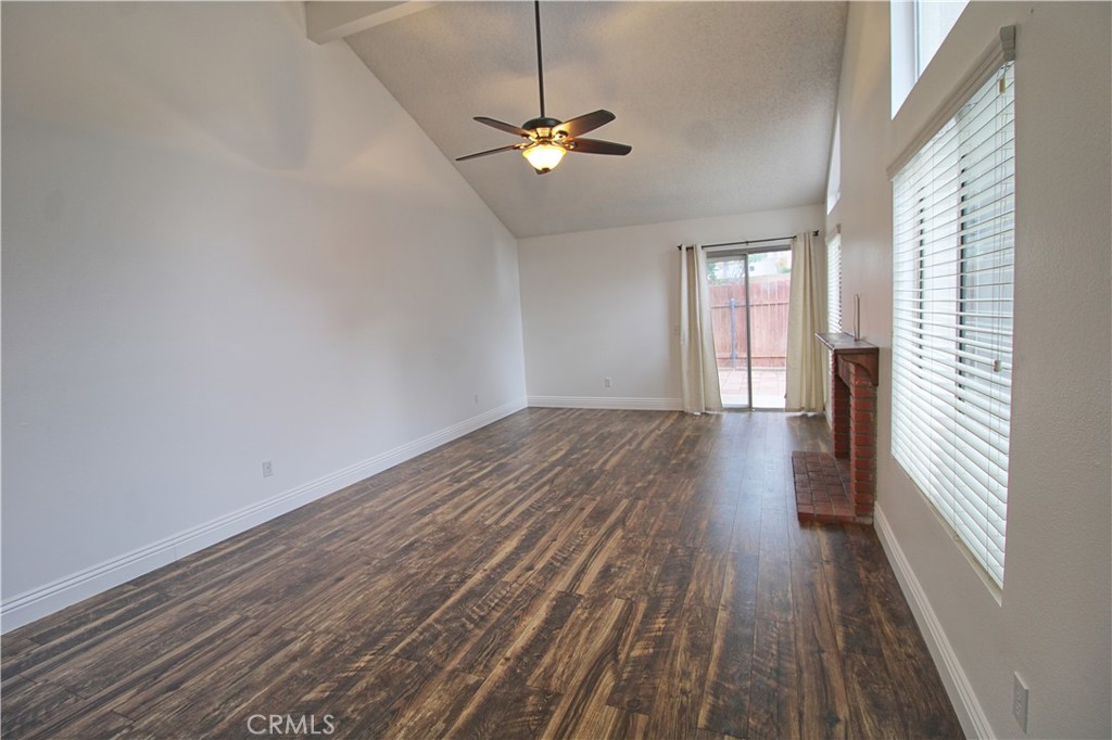 13597 Chaparral Trail Yucaipa, CA 92399 - Photo 2 of 12 a view of a room with wooden floor and ceiling fan
