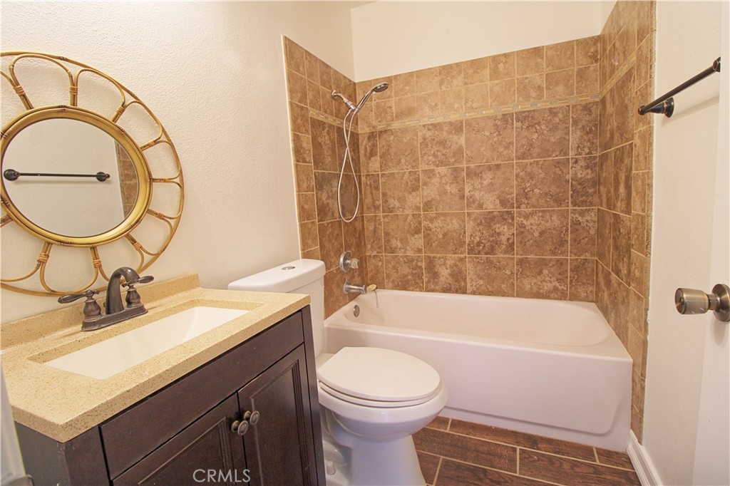 13597 Chaparral Trail Yucaipa, CA 92399 - Photo 10 of 12 a bathroom with a sink a toilet and a mirror