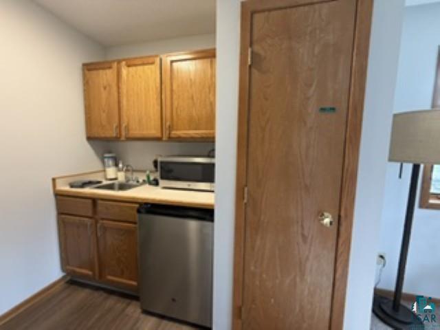6266 Giants Ridge Road Biwabik, MN 55705 - Photo 18 of 30 Wood-finish flooring, wood cabinetry, built-in sink, and stainless steel compact refrigerator