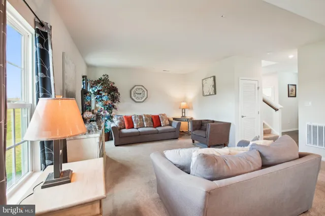 a living room with furniture and a lamp