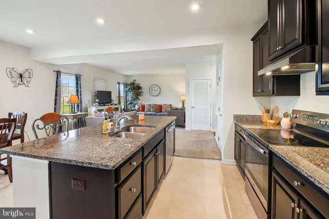 a kitchen with granite countertop a sink and cabinets