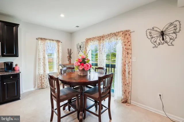 a view of a dining room with furniture and a window