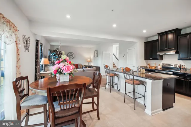 a view of a dining room with furniture and a kitchen