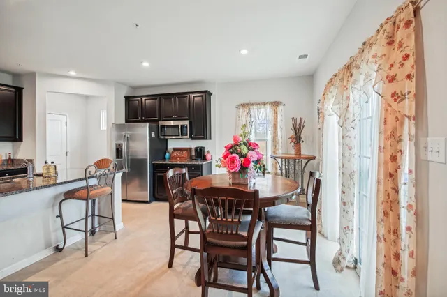 a dining room with furniture and window