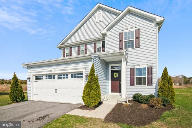 a view of a house with a yard and plants