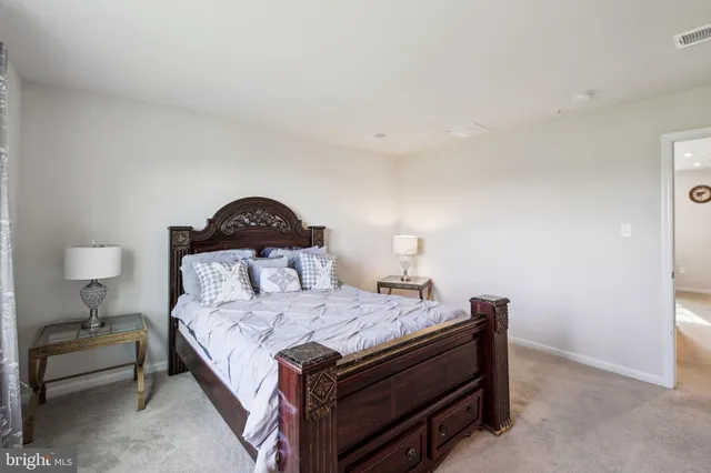 a bedroom with a bed and a lamp on table