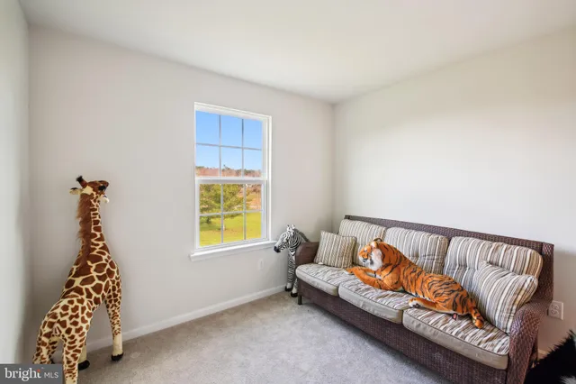 a view of a bedroom with a bed and a window