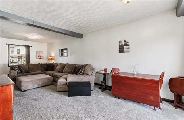 a bedroom with a bed a couch and a window