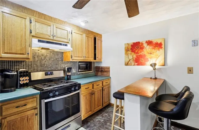 a kitchen with stainless steel appliances kitchen island granite countertop a sink and cabinets