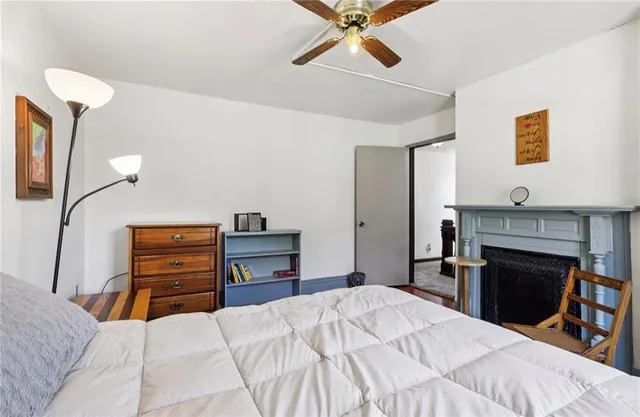 a bedroom with a bed and a large window with outer view