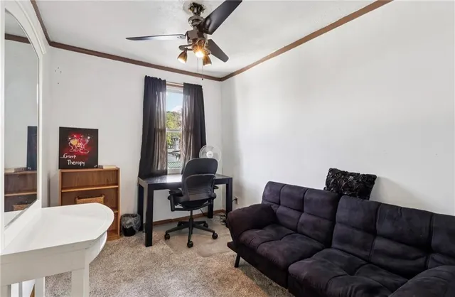 a view of a workspace with furniture and a window