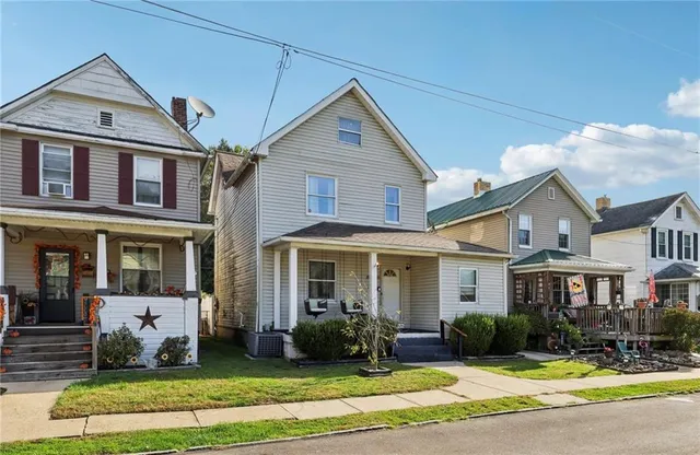 a front view of a house with a yard