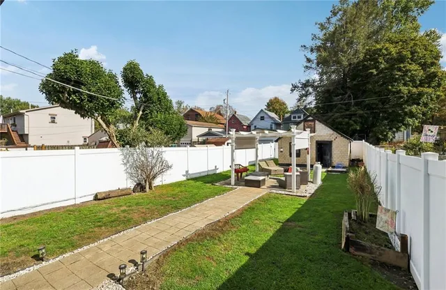 a view of a patio with table and chairs under an umbrella