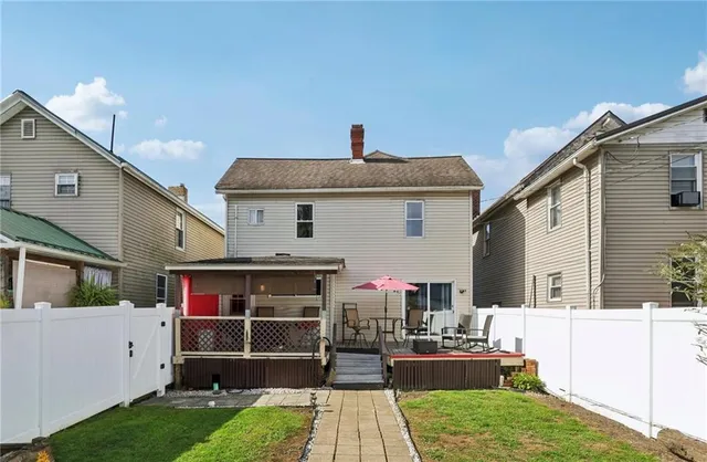 a view of a backyard with sitting area