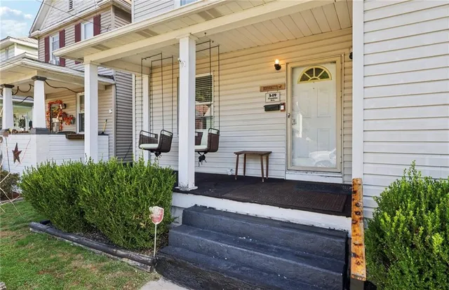 a view of a house with wooden floor and potted plants