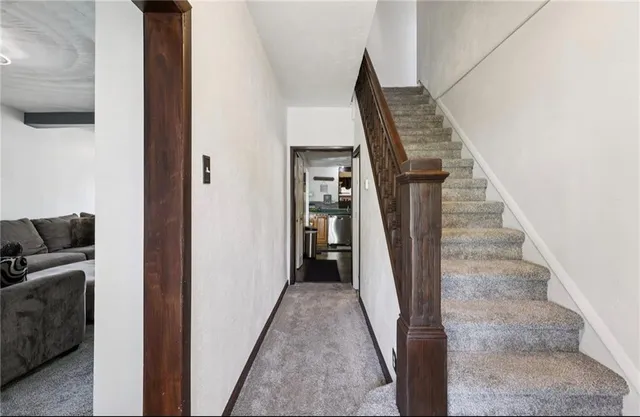 a kitchen with stainless steel appliances granite countertop a sink a stove cabinets counter space and a window