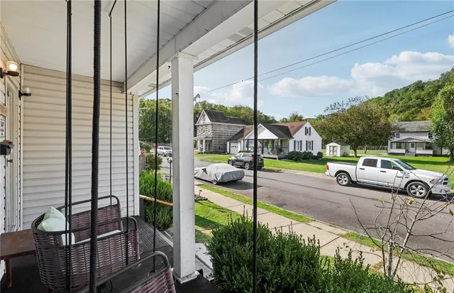 a view of a hallway with wooden floor and entryway