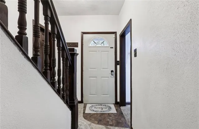a view of entryway and hall with furniture