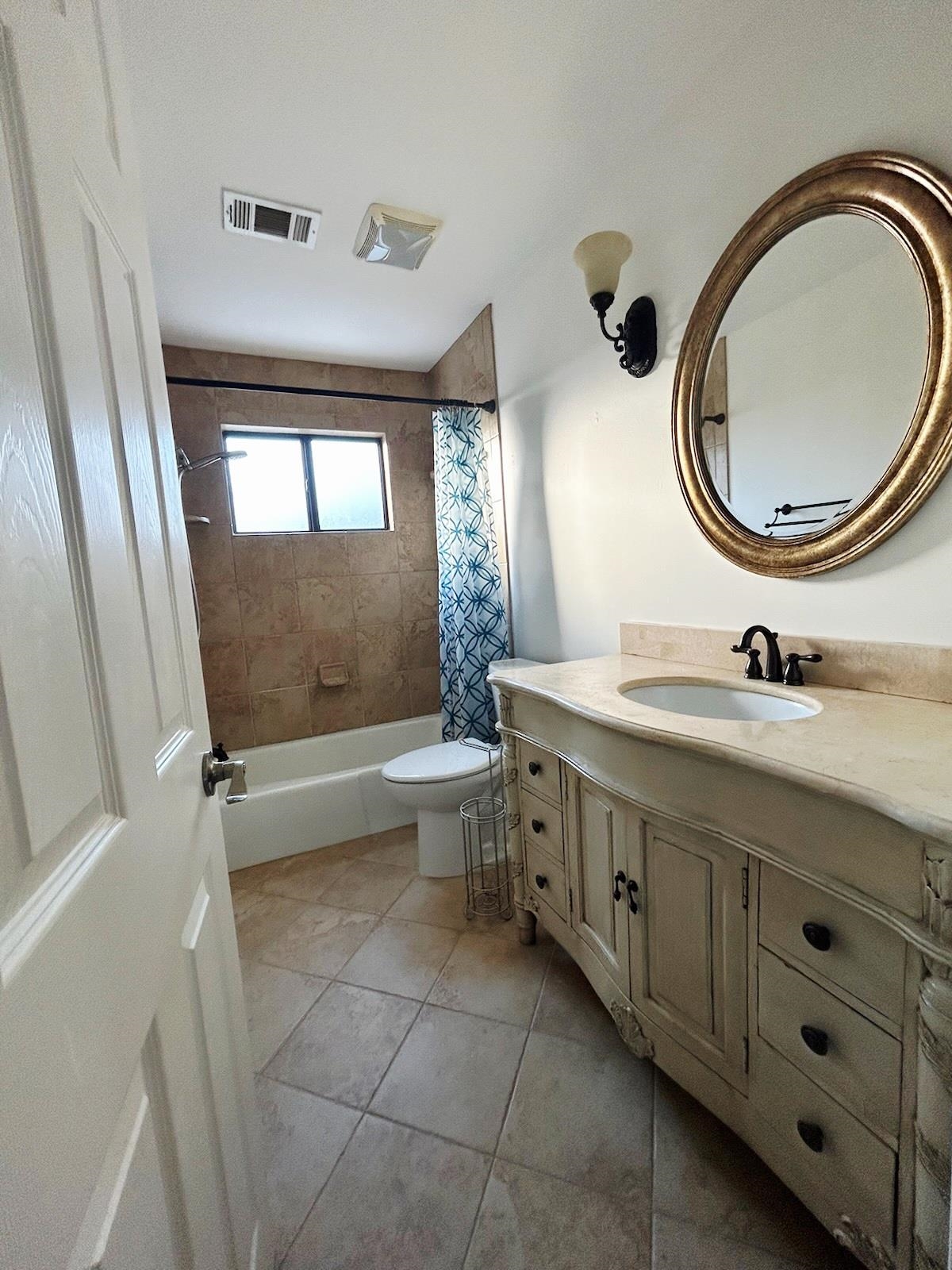 2095 Newfields Road Germantown, TN 38139 - Photo 29 of 34 Bathroom with vanity, shower / bathtub combination with curtain, and light tile patterned floors