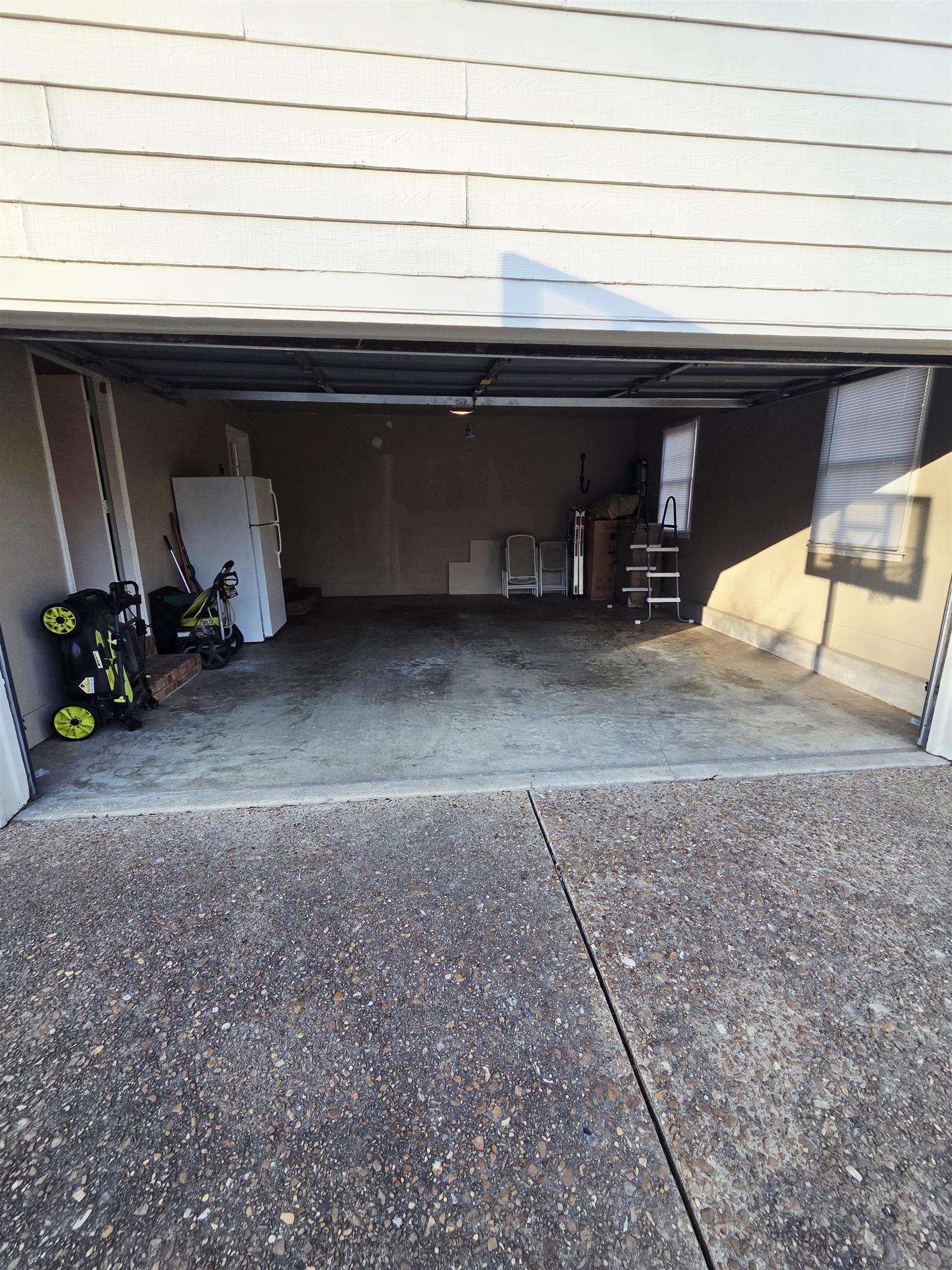 2095 Newfields Road Germantown, TN 38139 - Photo 31 of 34 Garage featuring freestanding refrigerator and driveway