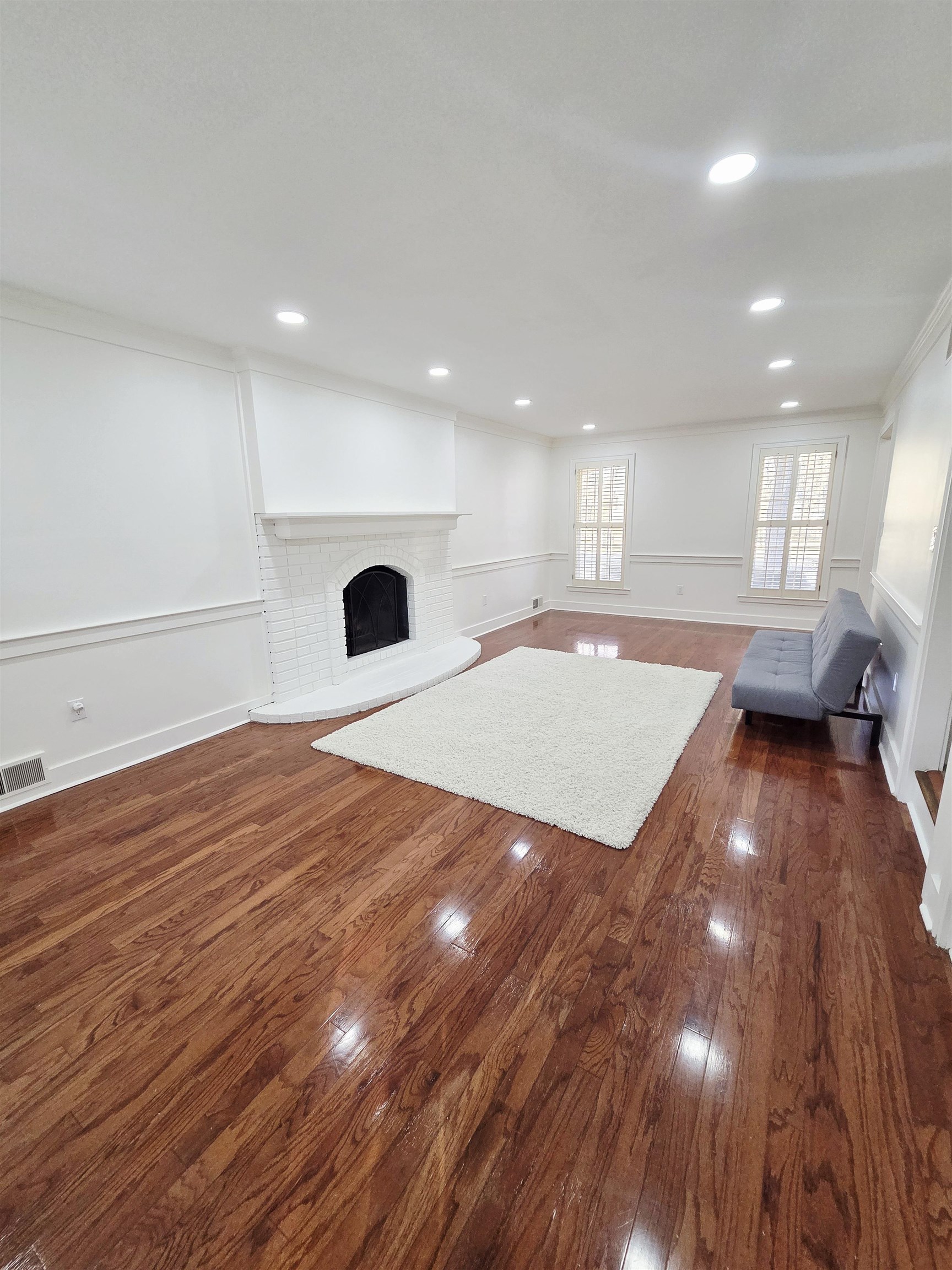 2095 Newfields Road Germantown, TN 38139 - Photo 4 of 34 Unfurnished living room with dark wood-style flooring, a fireplace, and recessed lighting