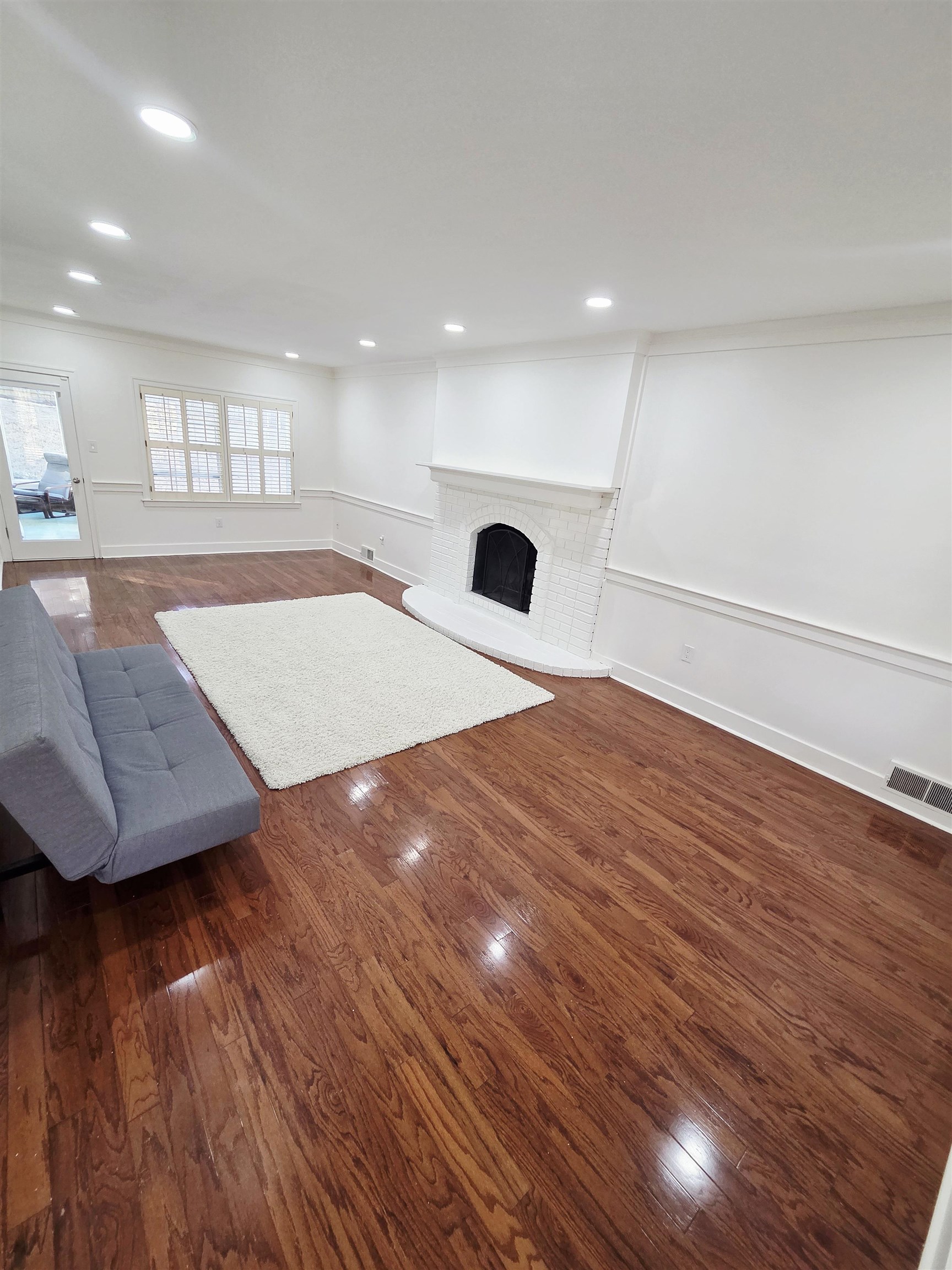 2095 Newfields Road Germantown, TN 38139 - Photo 5 of 34 Unfurnished living room featuring dark wood-type flooring, a fireplace, and recessed lighting