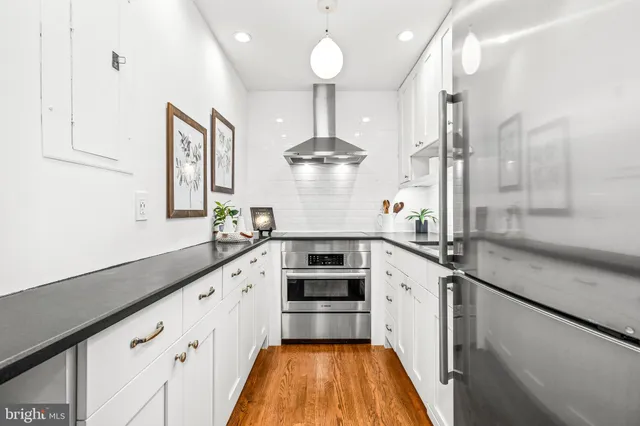 a kitchen with a stove and a chandelier
