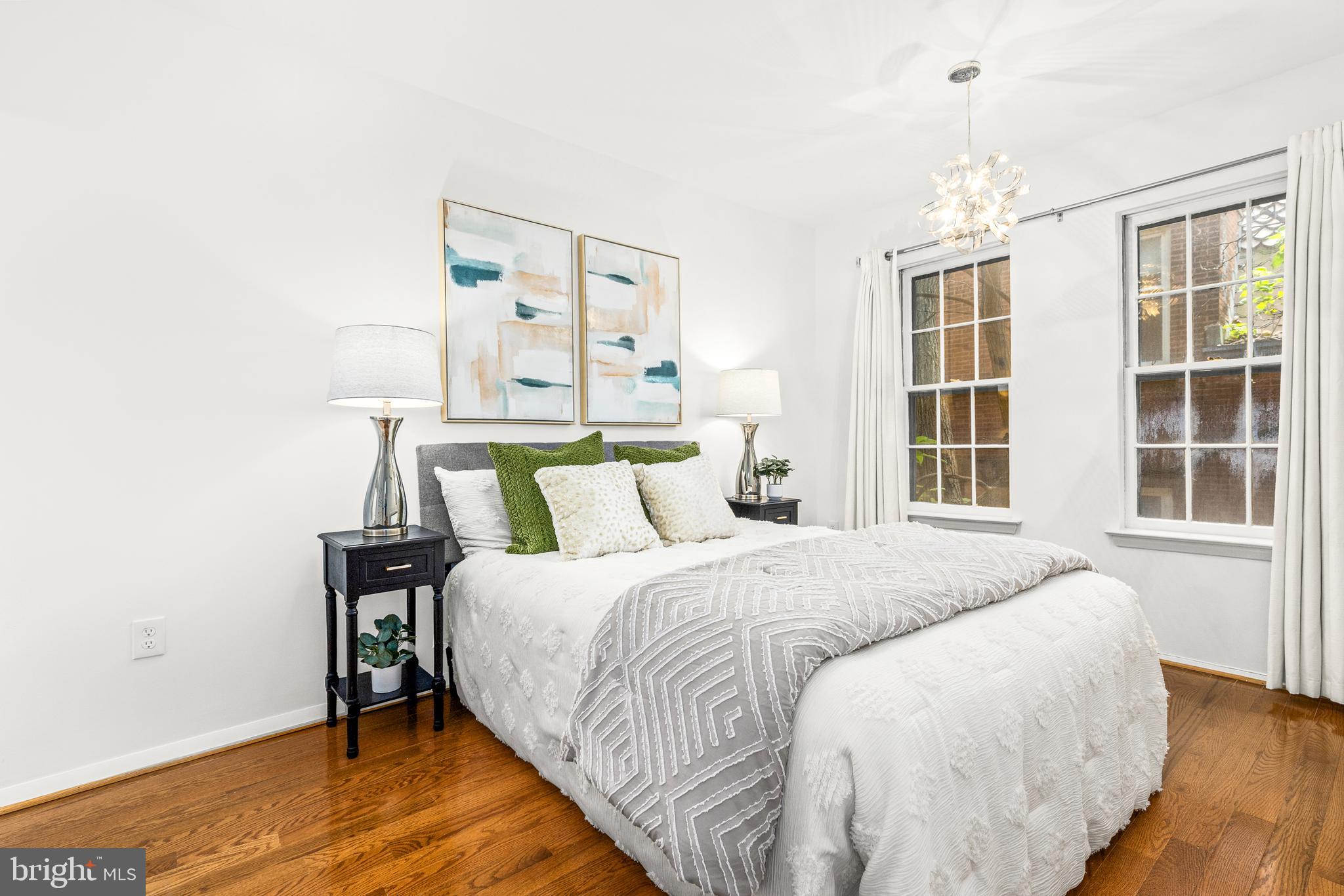 1730 16th Street Northwest, Unit 14 Washington, DC 20009 - Photo 18 of 30 a bedroom with a bed and wooden floor