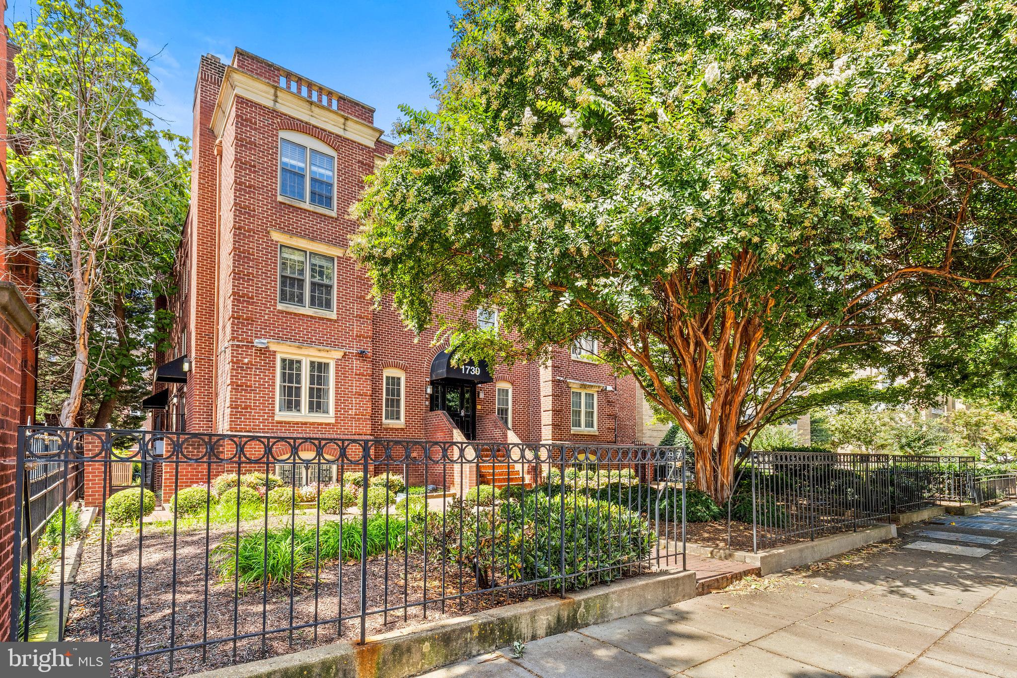 1730 16th Street Northwest, Unit 14 Washington, DC 20009 - Photo 2 of 30 a front view of a house with a garden