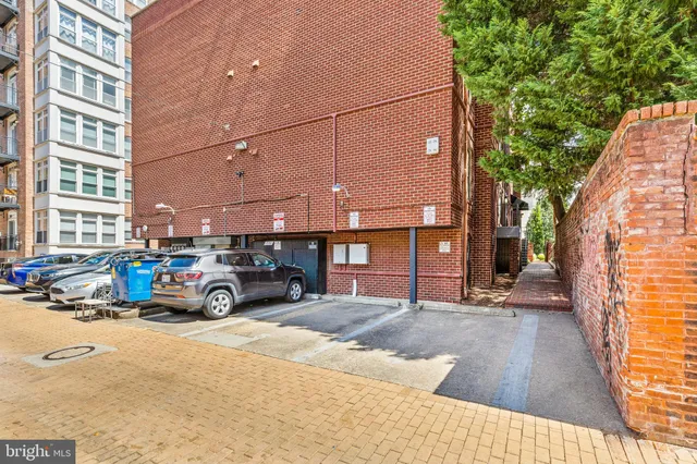 a blue and white car parked in front of a building