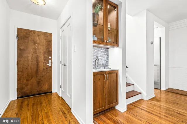 a view of a hallway with wooden floor and entryway