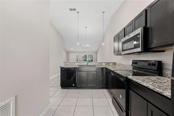 a kitchen with stainless steel appliances granite countertop a sink and stove top oven