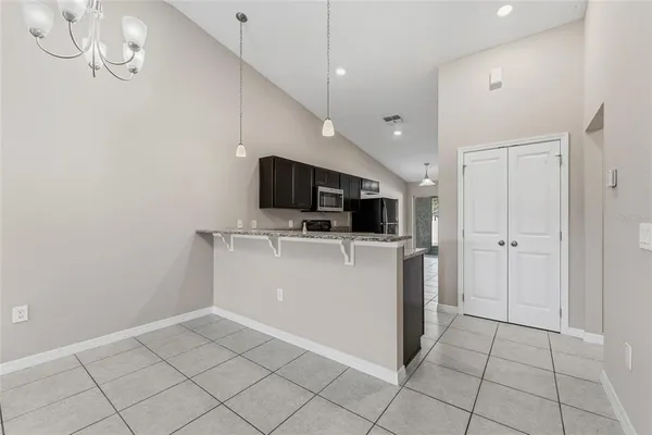 a view of kitchen with microwave and cabinets