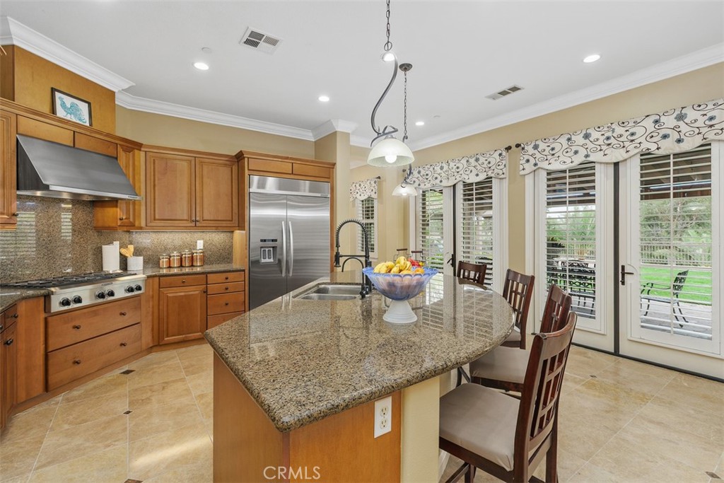 13337 Hunt Club Drive Rancho Cucamonga, CA 91739 - Photo 9 of 45 Kitchen with granite countertop, pendant lights, marble flooring, and two double French doors