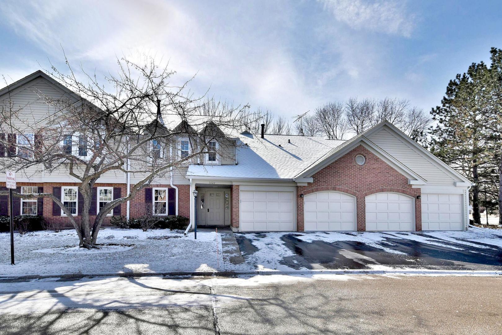 1622 Hadley Court, Unit C1 Wheeling, IL 60090 - Photo 1 of 32 a front view of a house with a yard