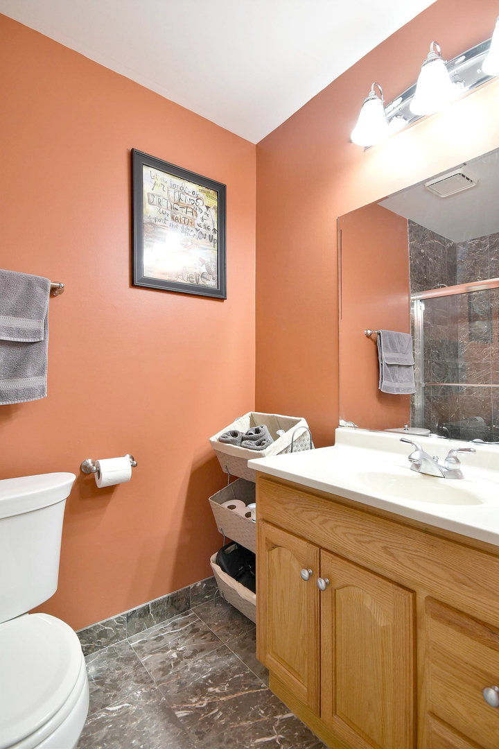 1622 Hadley Court, Unit C1 Wheeling, IL 60090 - Photo 18 of 32 a bathroom with a granite countertop sink mirror vanity and toilet