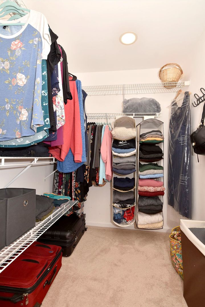 1622 Hadley Court, Unit C1 Wheeling, IL 60090 - Photo 21 of 32 a view of walk in closet with clothes and shoes