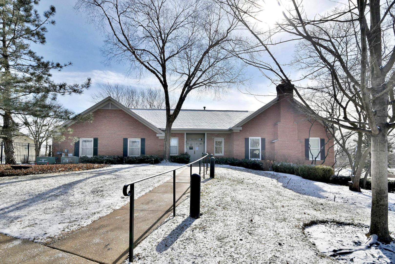 1622 Hadley Court, Unit C1 Wheeling, IL 60090 - Photo 28 of 32 a front view of house with yard covered in snow