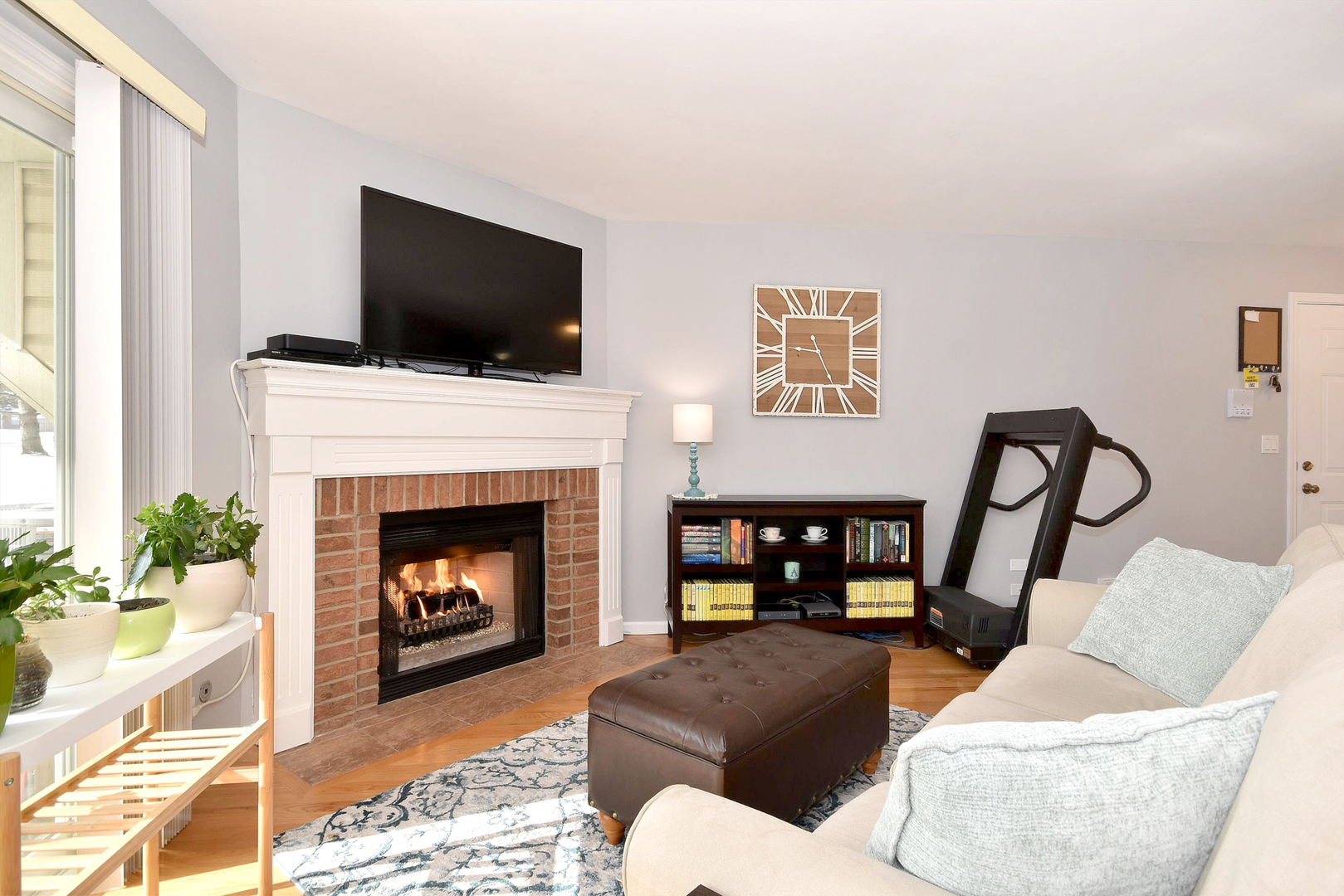 1622 Hadley Court, Unit C1 Wheeling, IL 60090 - Photo 4 of 32 a living room with furniture a flat screen tv and a fireplace