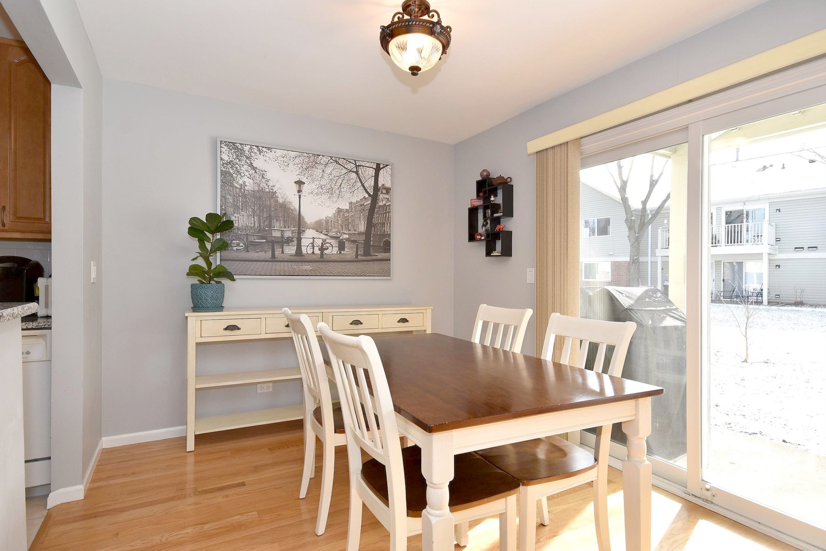 1622 Hadley Court, Unit C1 Wheeling, IL 60090 - Photo 7 of 32 a view of a dining room with furniture a chandelier and wooden floor