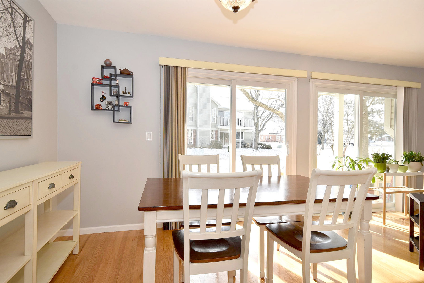1622 Hadley Court, Unit C1 Wheeling, IL 60090 - Photo 8 of 32 a view of a dining room with furniture a chandelier and wooden floor