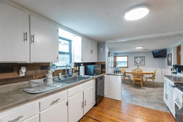 a kitchen with lots of counter space and windows