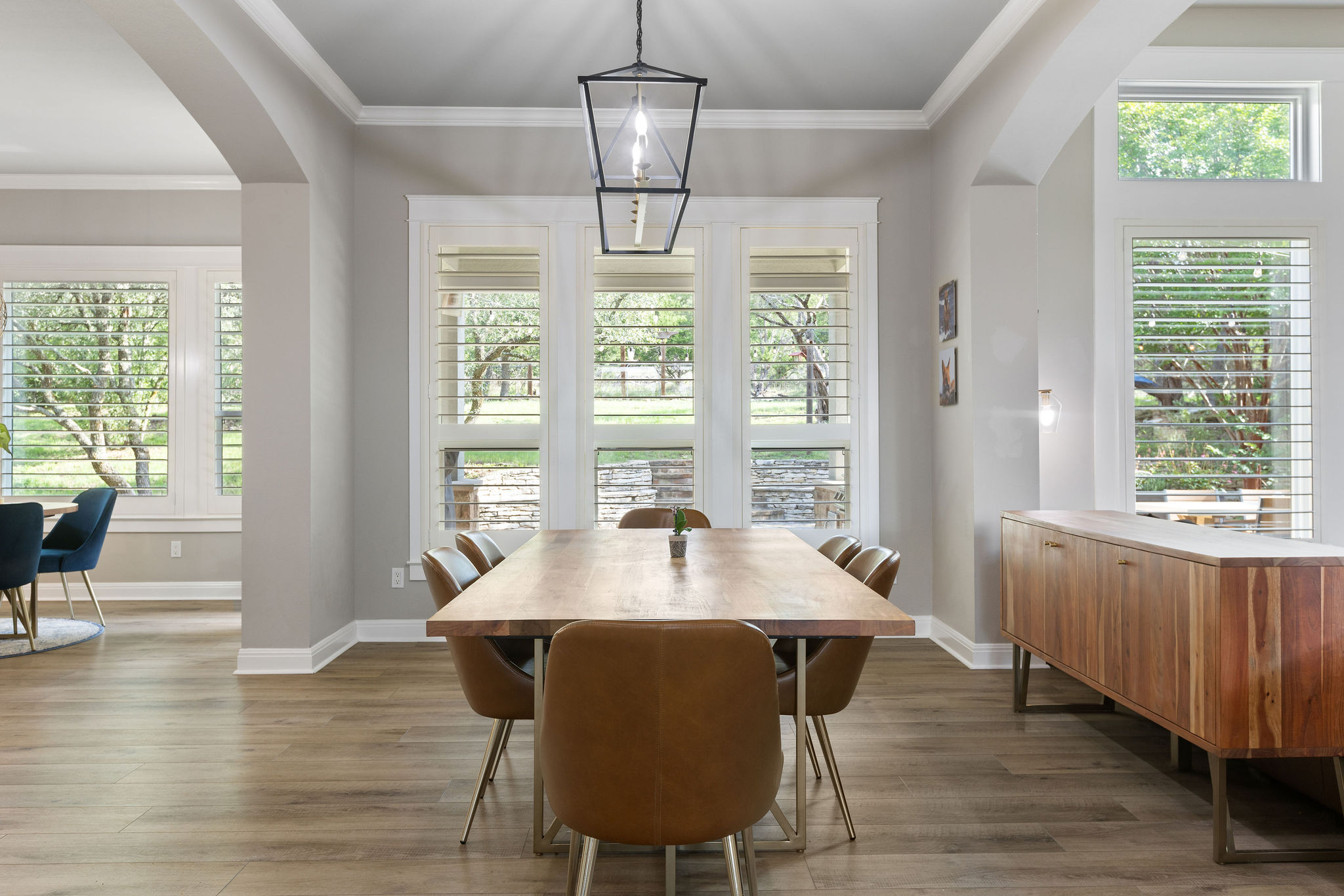 279 Rugged Earth Drive Austin, TX 78737 - Photo 12 of 40 Dining room featuring arched walkways, wood finished floors, and ornamental molding