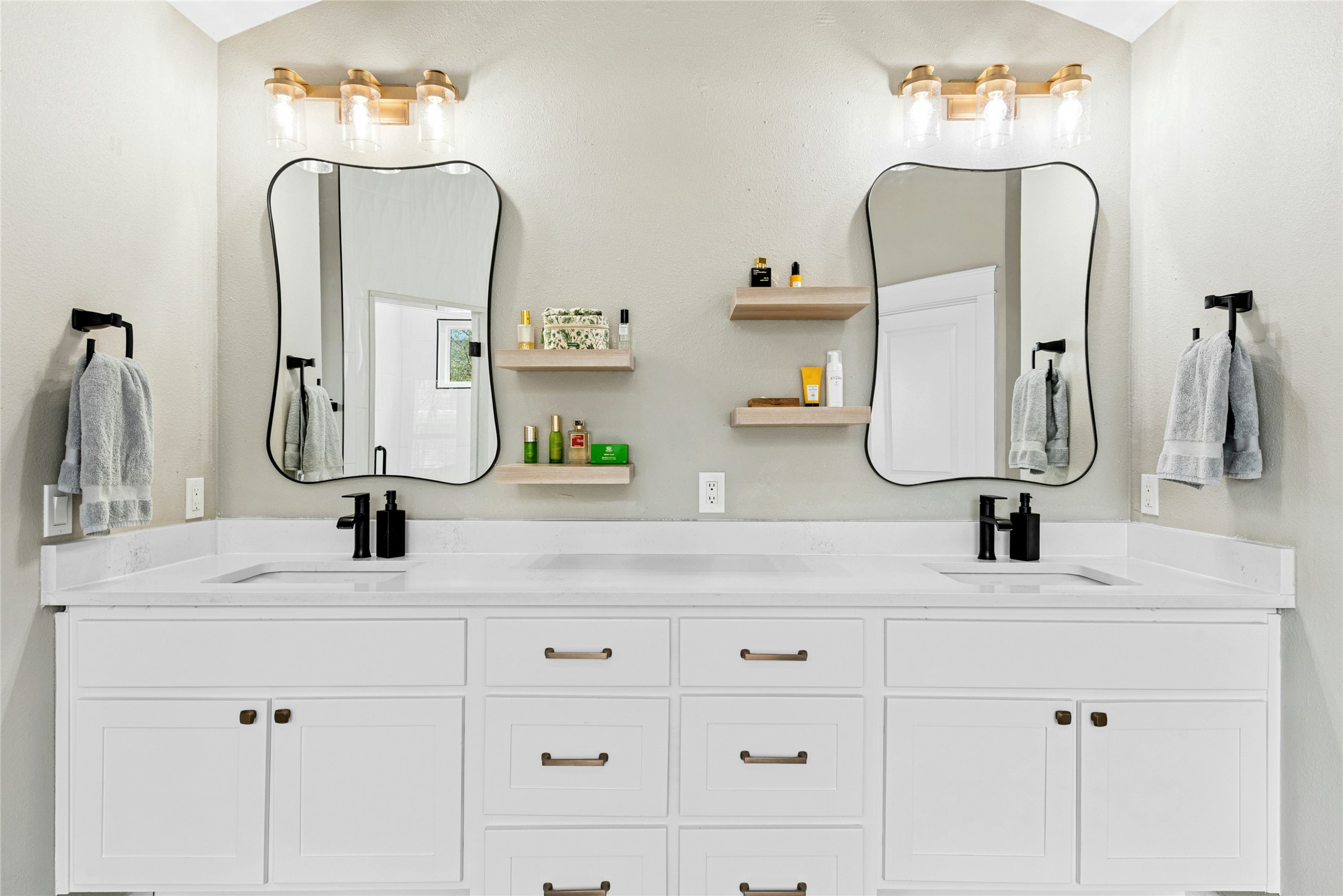 279 Rugged Earth Drive Austin, TX 78737 - Photo 23 of 40 Bathroom featuring double vanity and vaulted ceiling