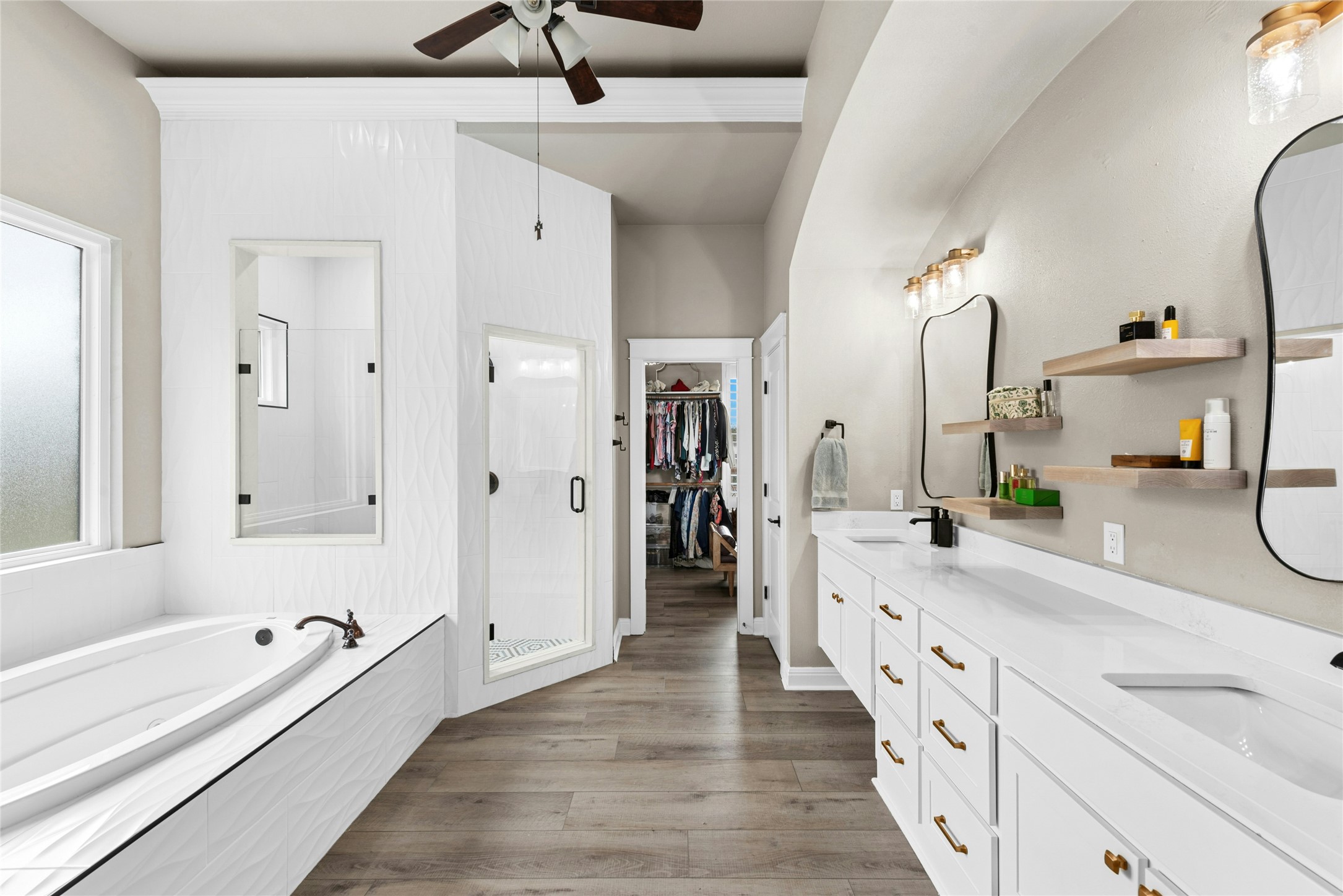 279 Rugged Earth Drive Austin, TX 78737 - Photo 25 of 40 Full bath with double vanity, dark wood-type flooring, a spacious closet, a bath, and a stall shower