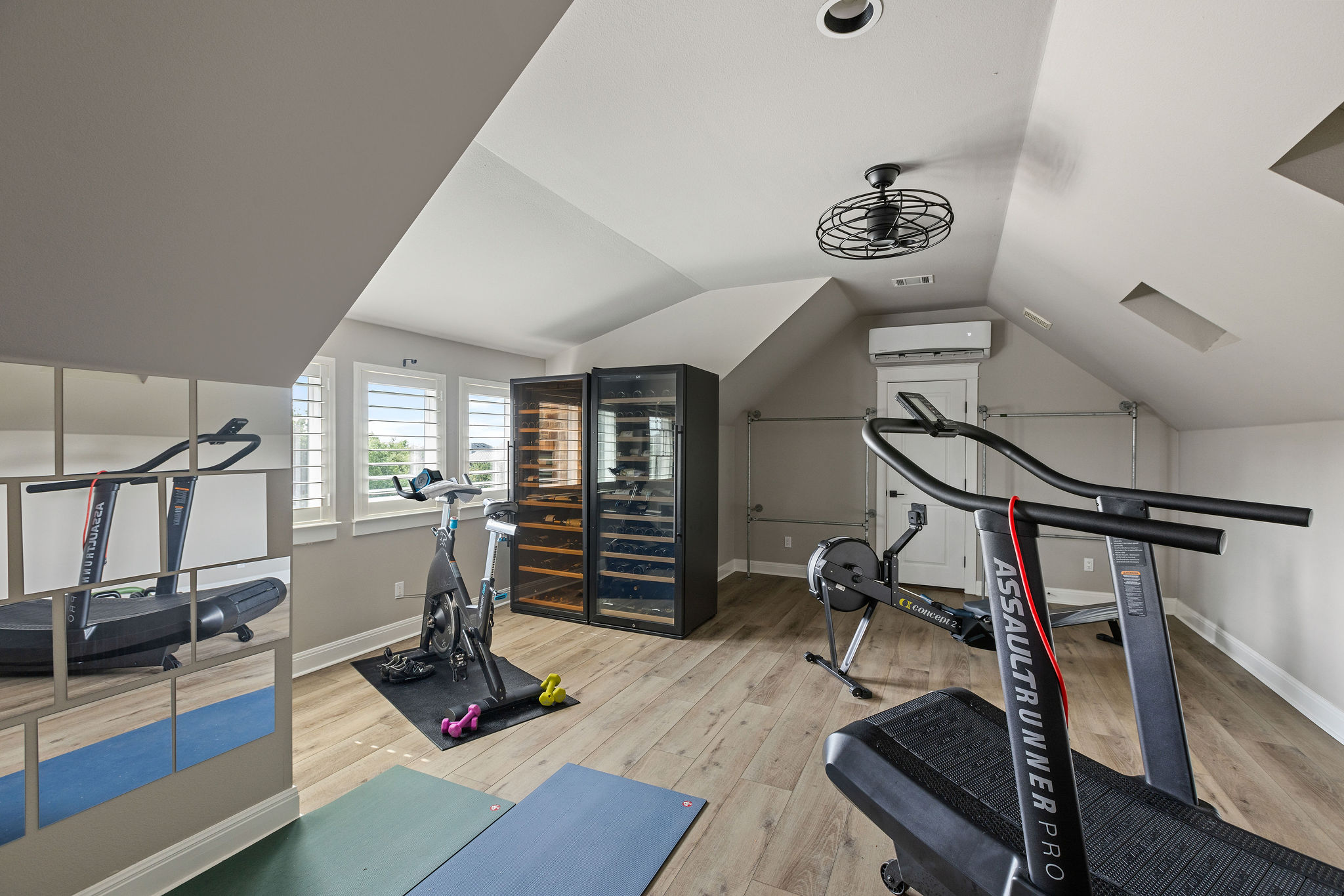 279 Rugged Earth Drive Austin, TX 78737 - Photo 35 of 40 Exercise area featuring wood finished floors, vaulted ceiling, and an AC wall unit