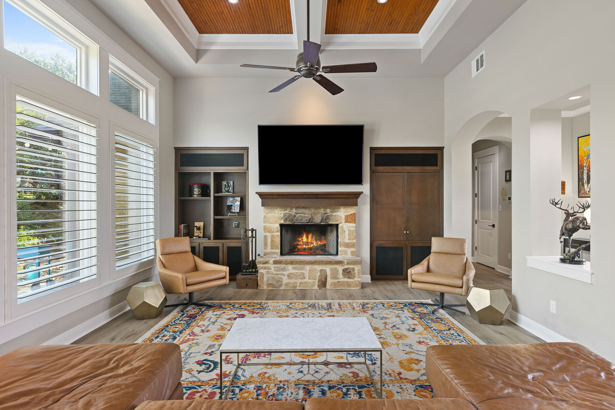 279 Rugged Earth Drive Austin, TX 78737 - Photo 4 of 40 Living room with a towering ceiling, recessed lighting, wood finished floors, crown molding, and a fireplace