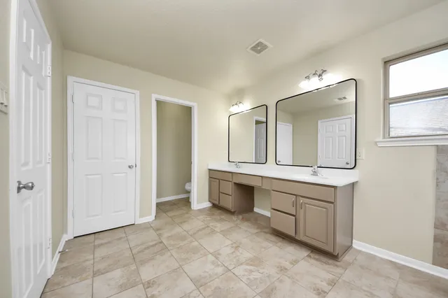 a view of a bathroom with a tub shower and a sink